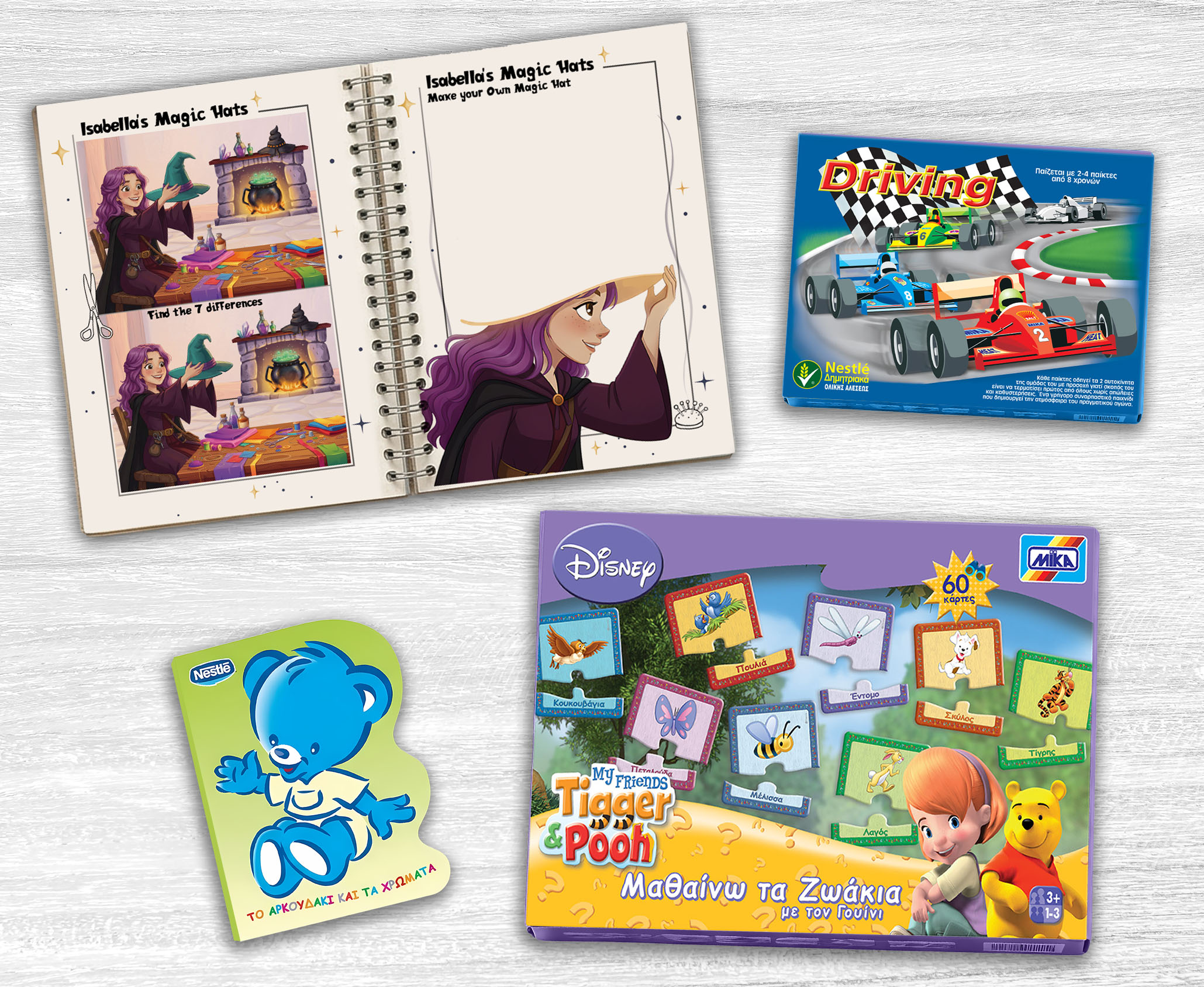 Children's Educational book design, Board Games & Puzzles. Educational portfolio flat lay showing an illustrated children's board game box, open Isabella's Magic Hats activity book with puzzle pages and a Nestle shaped board book on a white desk
